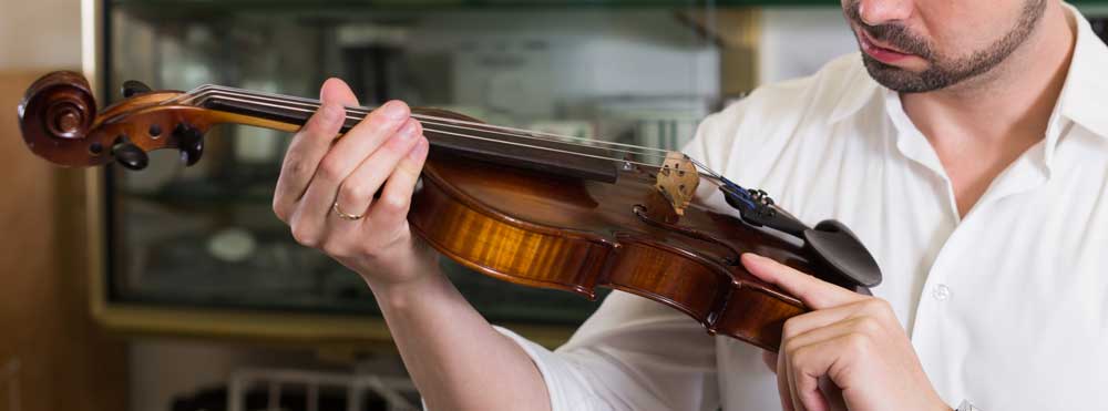 Man Inspecting A Good Violin?